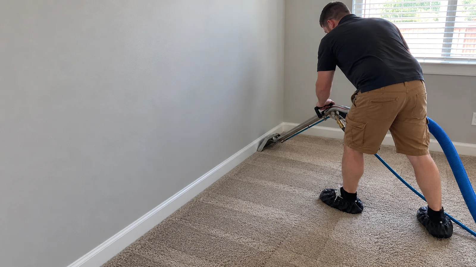 A cleaner working on a residential carpet